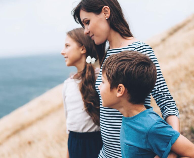 mom walking with preteens outdoors